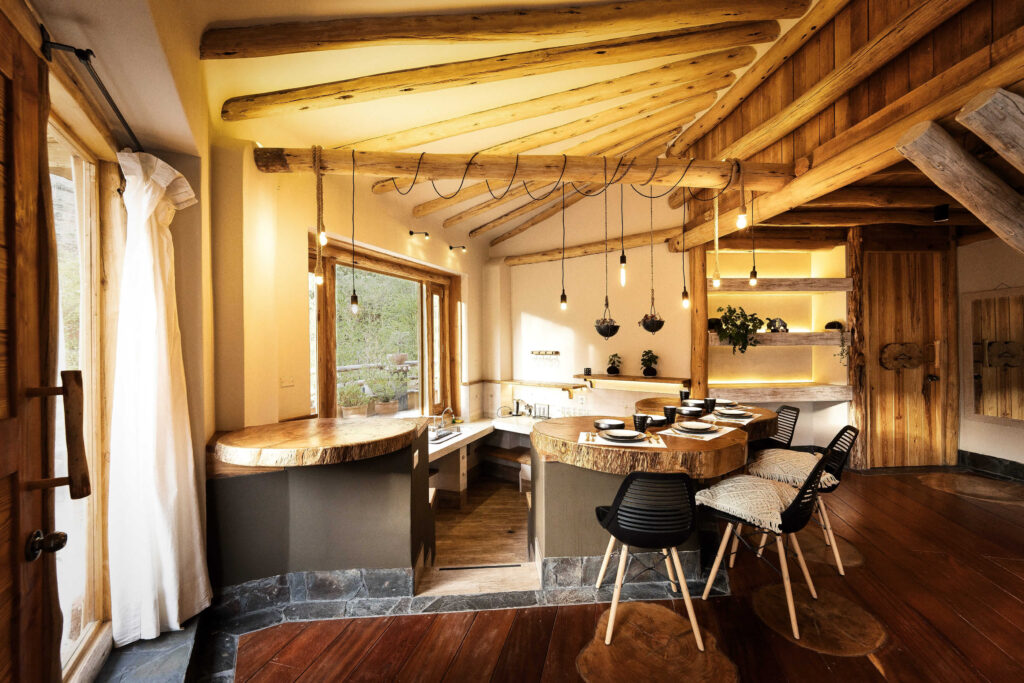 Rustic yet modern dining area in a luxury ayahuasca retreat room with natural wood accents and ample sunlight