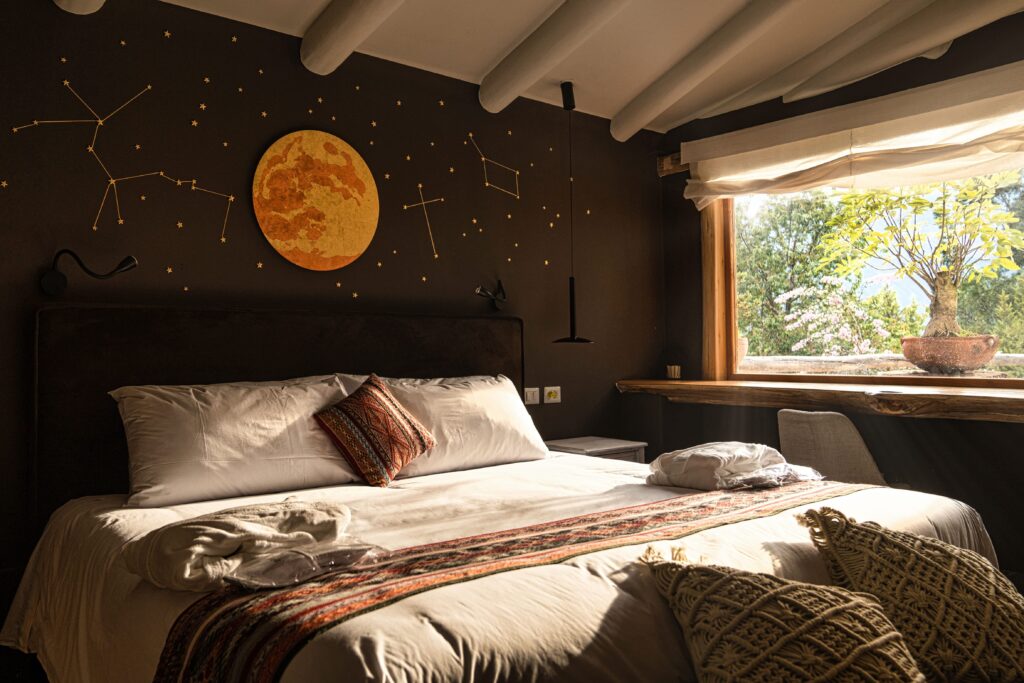 Elegant room at a luxury ayahuasca retreat with celestial-themed decor and a view of nature