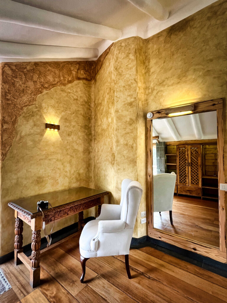 Immerse in the tranquil luxury of a Sacred Valley ayahuasca retreat, where this serene nook, with its elegant chair and beautifully carved table, awaits your reflective moments