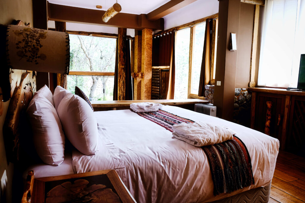 Cozy room with natural wood decor and ample window light offers a serene, comfortable retreat.