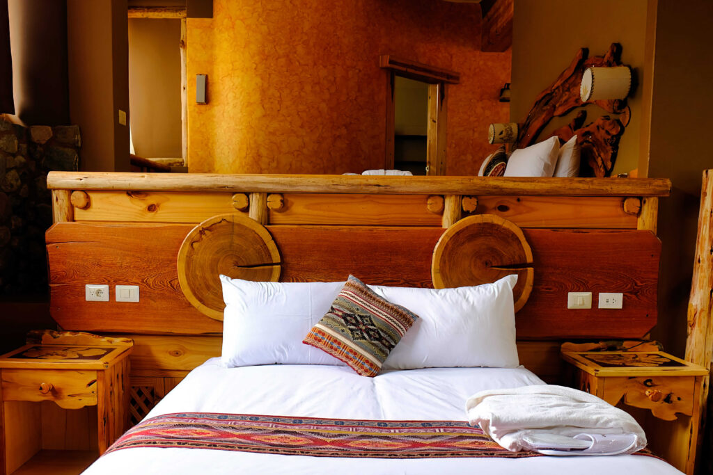 Rustic elegance with a custom wooden bed frame, creating a warm, inviting bedroom ambiance.