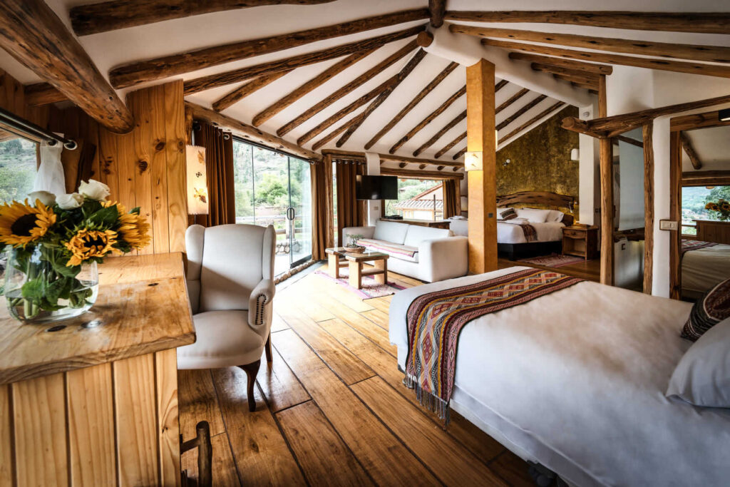 The Sunbeam Suite at Ayahuasca Lux presents a harmonious blend of rustic charm and comfort, with sunlit spaces and wooden accents creating a serene retreat.