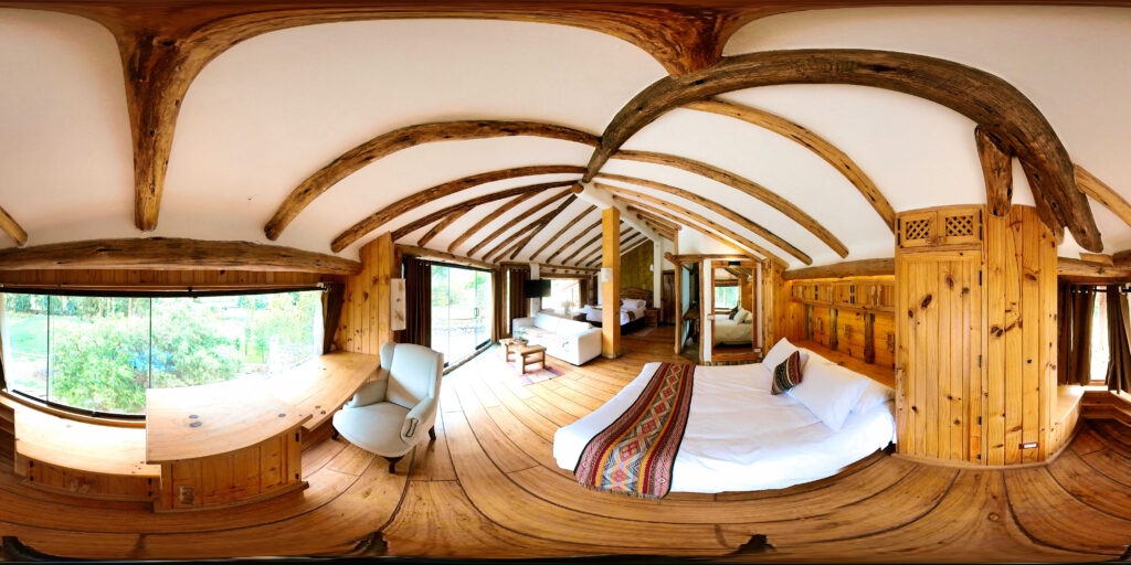 The Sunbeam Suite at Ayahuasca Lux envelops you in a rustic charm, with its sweeping wooden arches and earthy tones, while offering a spacious and serene retreat amidst nature's embrace.